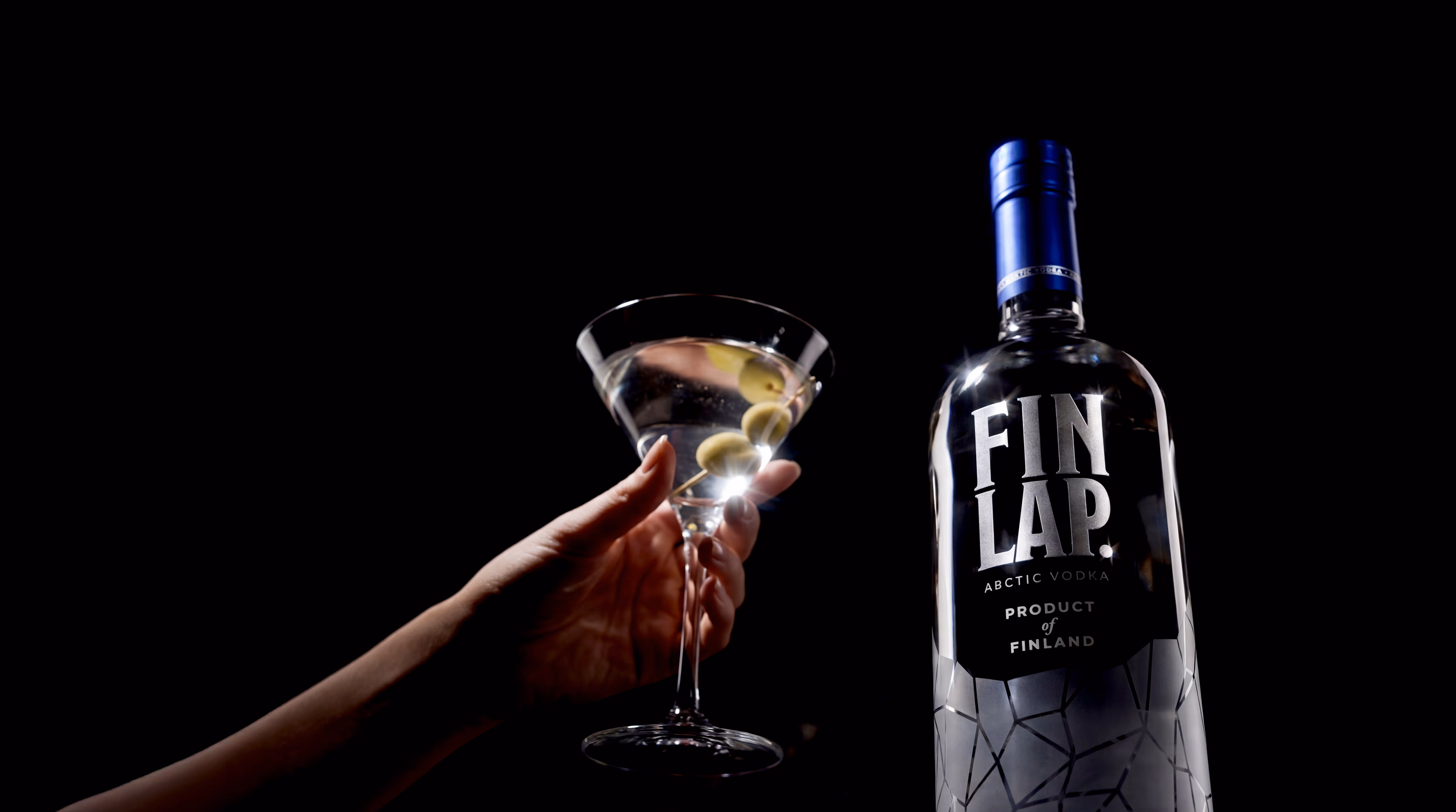 A martini with olives beside FINLAP.